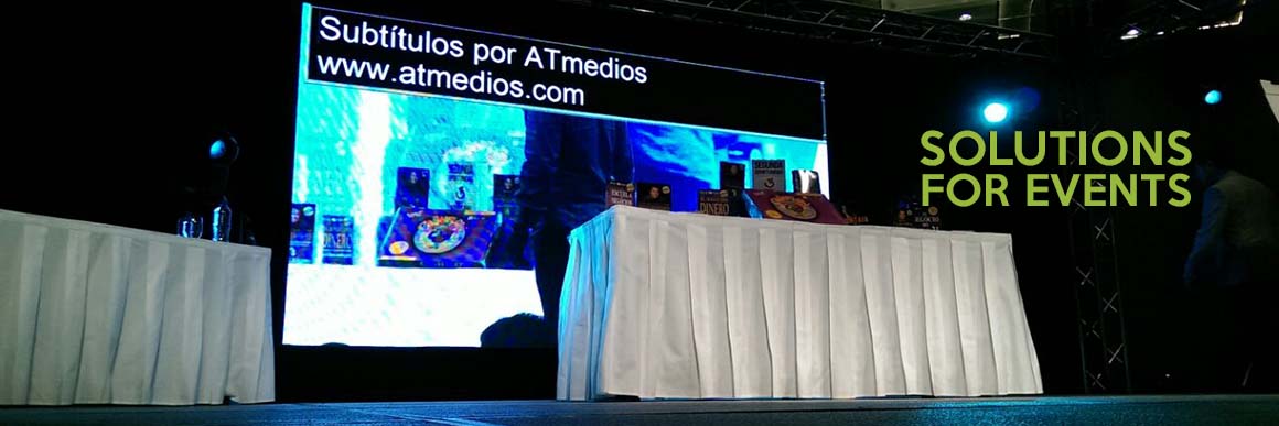 On a stage screen, subtitles by ATmedios.